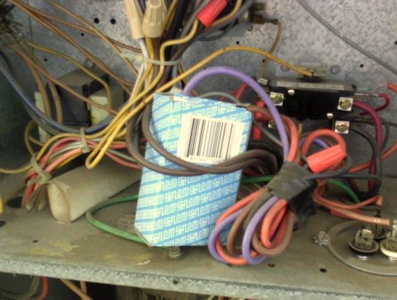 condenser fan motor run capacitor stuffed inside of a box